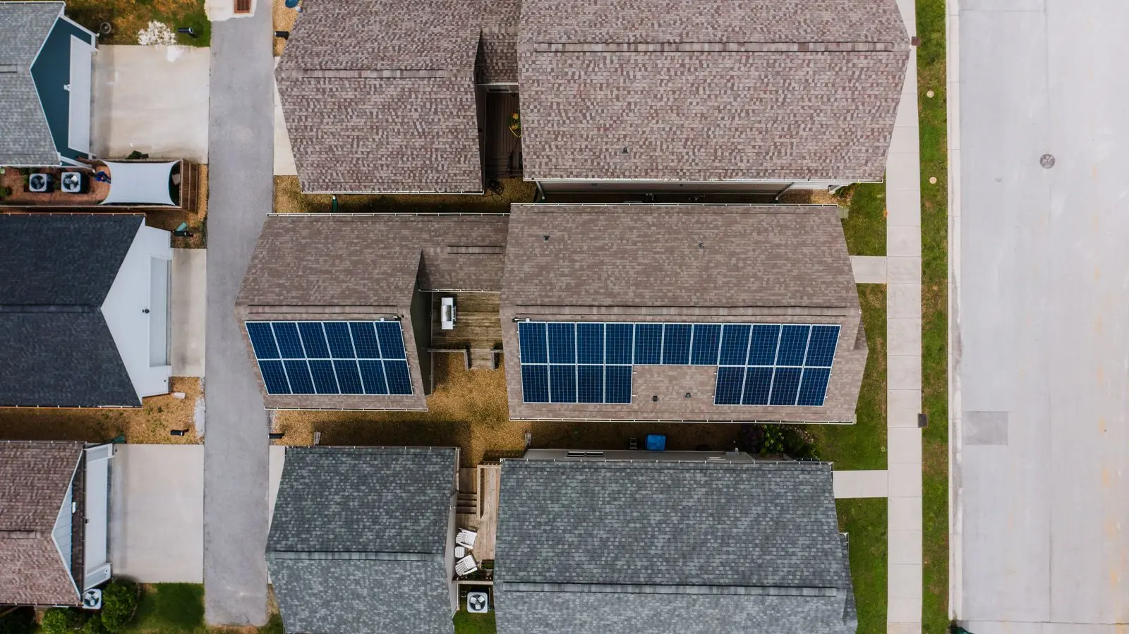 Looking straight down on rooftops, some covered with solar panels