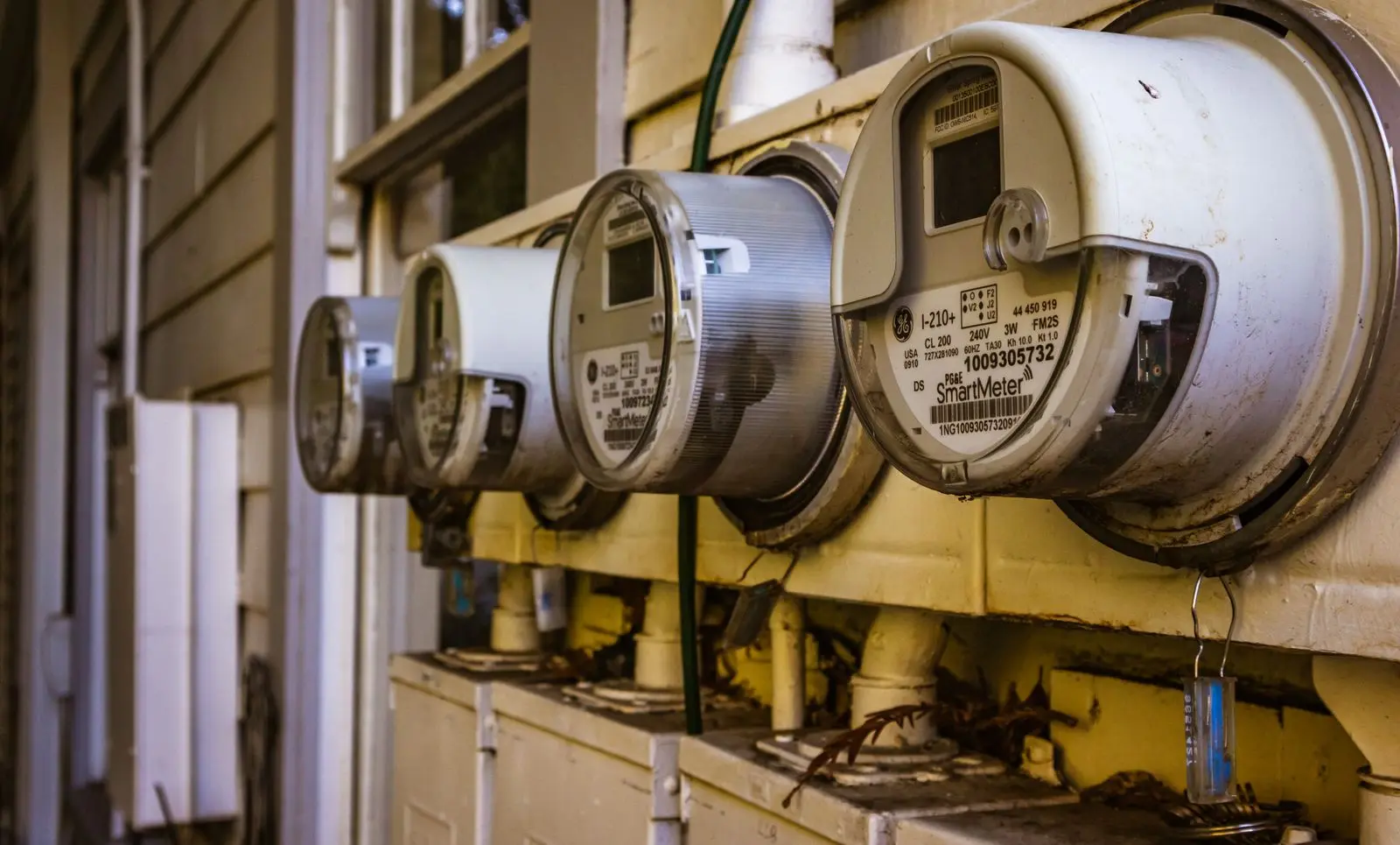 A bank of electricity meters on the side of a building